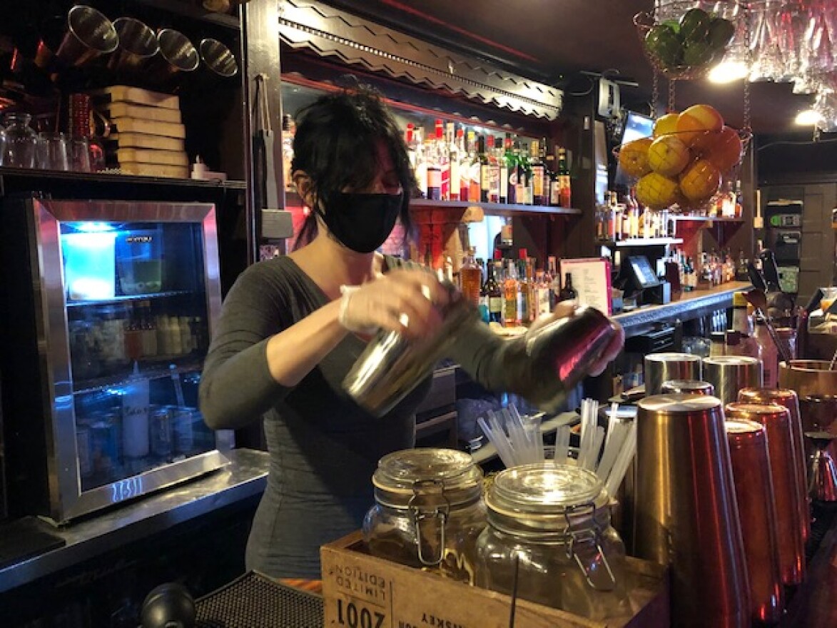 A bartender mixes a drink at Albany's Savoy Taproom. Due to rising COVID-19 rates, the restaurant has curtailed indoor dining for now, but is offering takeout and delivery.